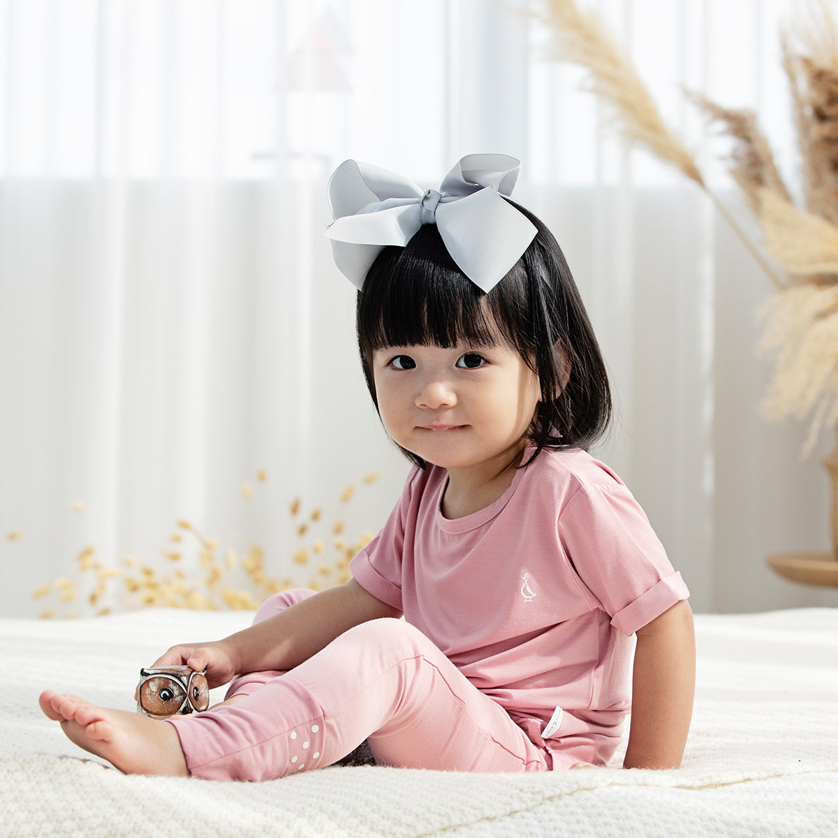 Baby girl wearing premium bamboo leggings, perfect for sensitive skin.