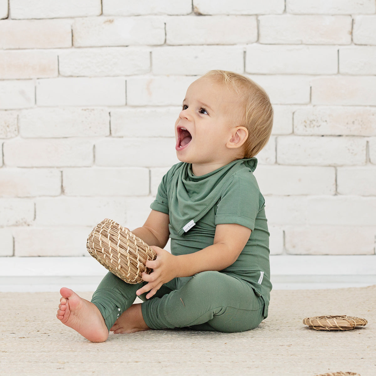 Happy baby wearing soft bamboo leggings, ideal for play.