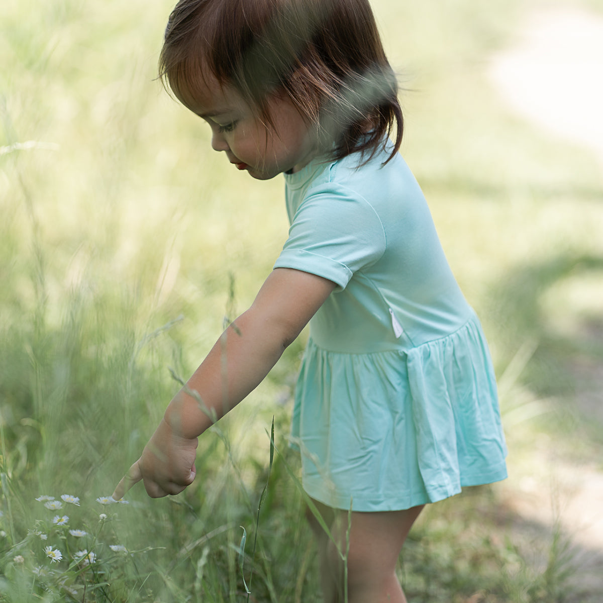 Curious baby exploring in RAPH&REMY® Bamboo Baby Onesie Dress