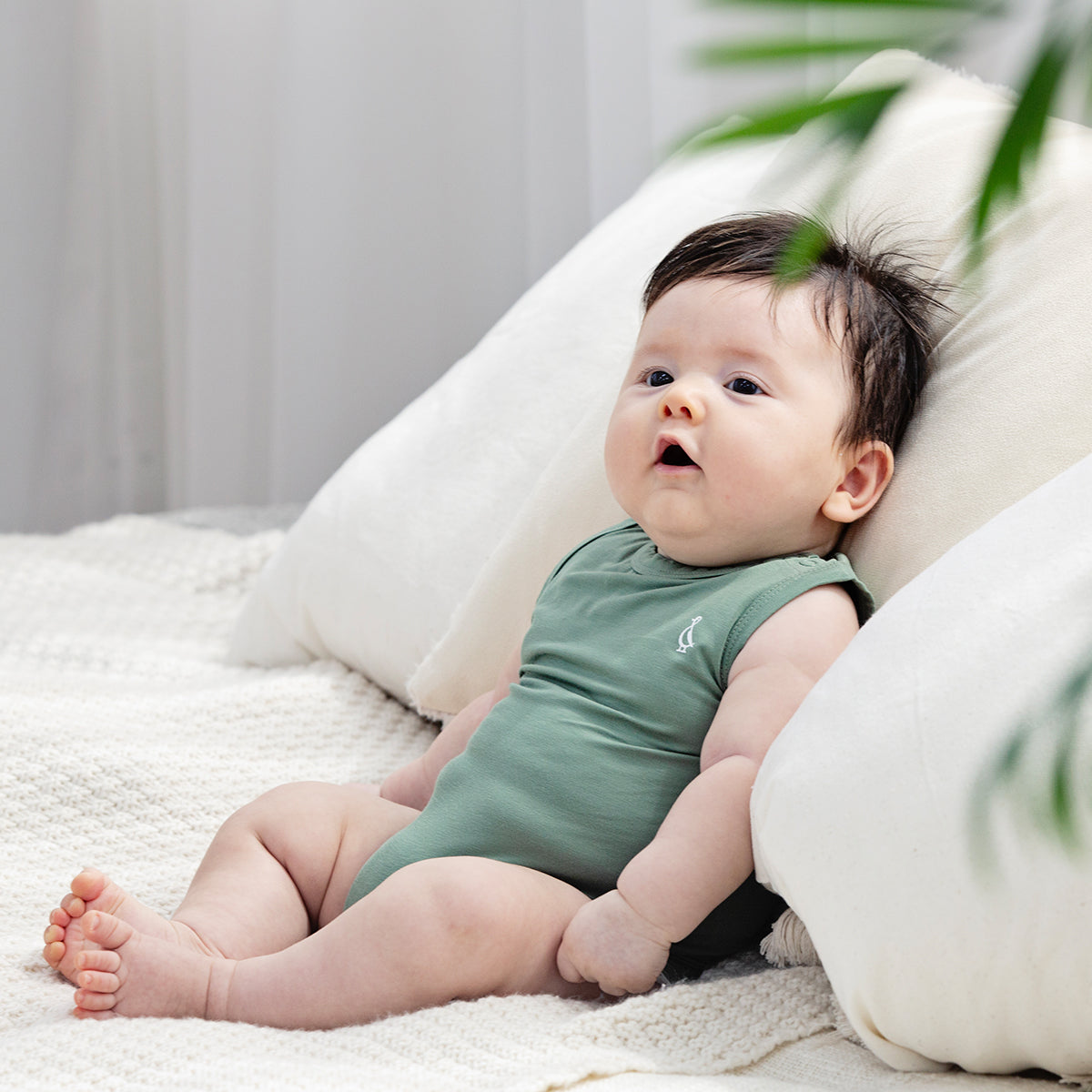 Natural bamboo sleeveless onesie for babies, soft on the skin.