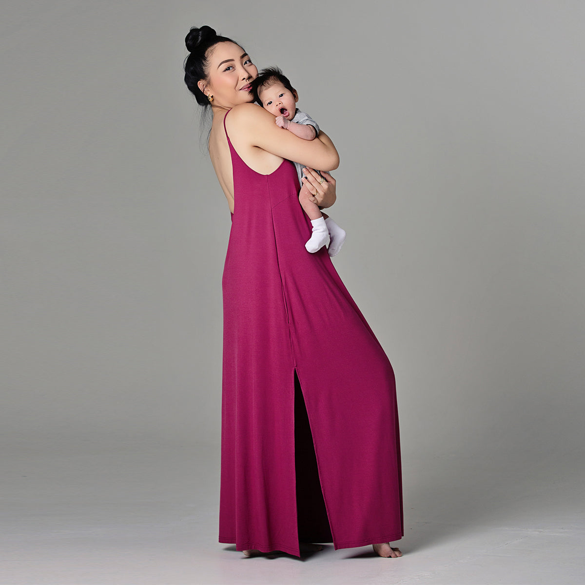 Woman holding baby in Ari dress in sangria color