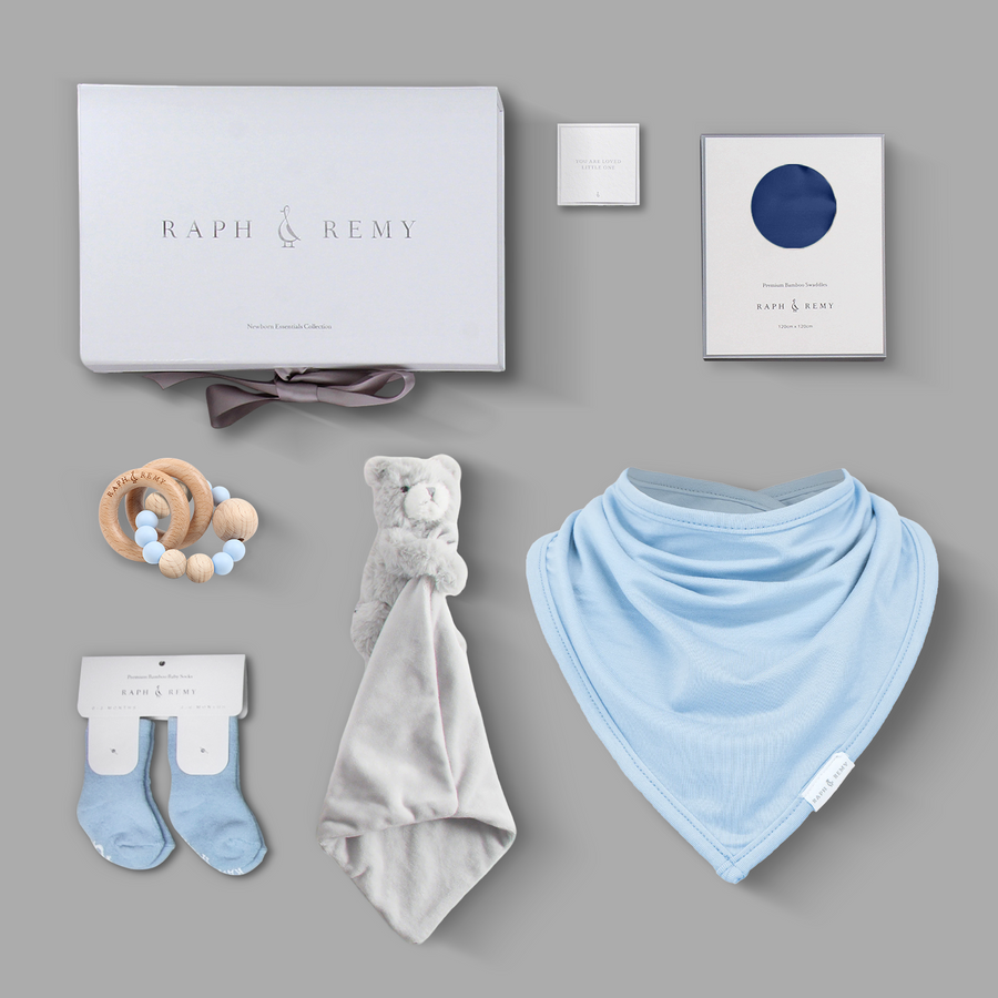 Raph & Remy newborn gift box featuring mauve bandana bib, bear security blanket, pink socks and personalised gift card
