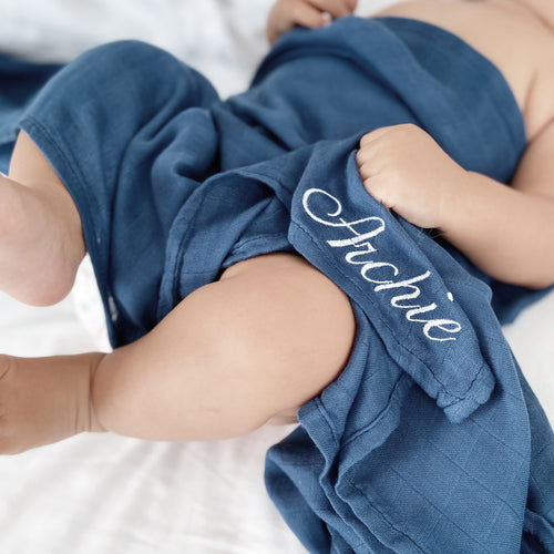 Baby wrapped in personalized Premium Bamboo Swaddle by RAPH&REMY®