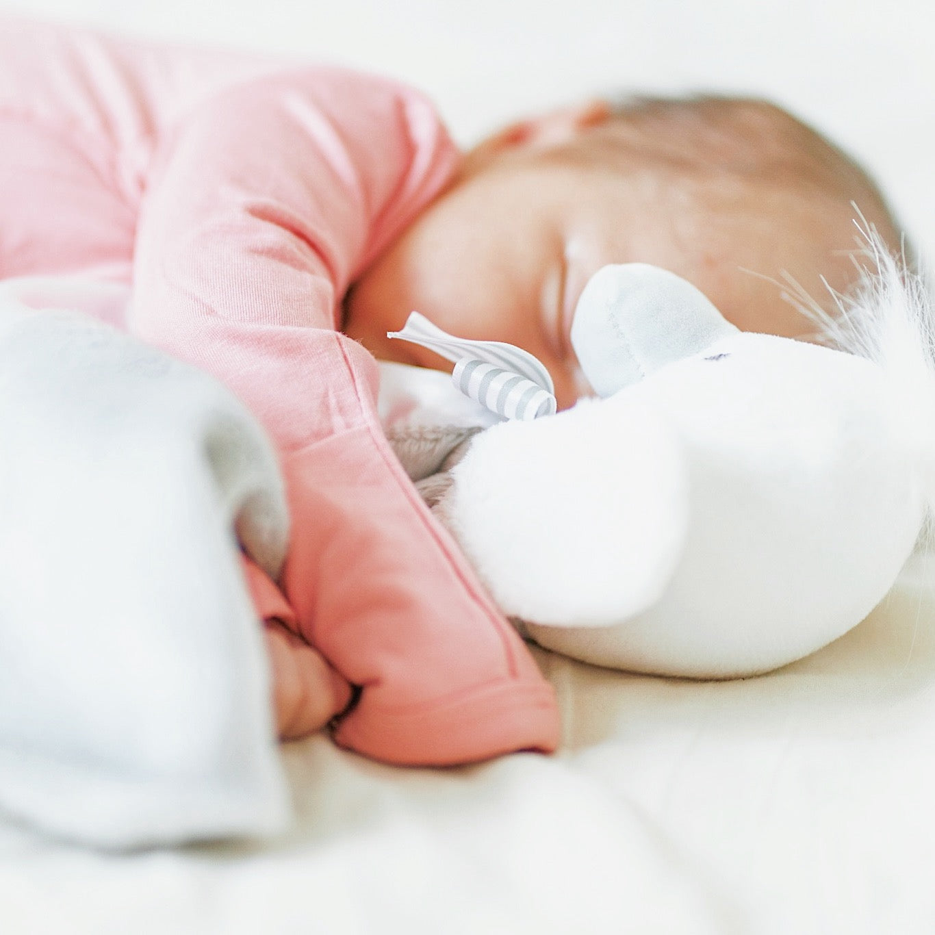 Newborn snuggling with SootherBuddy™ Security Blanket