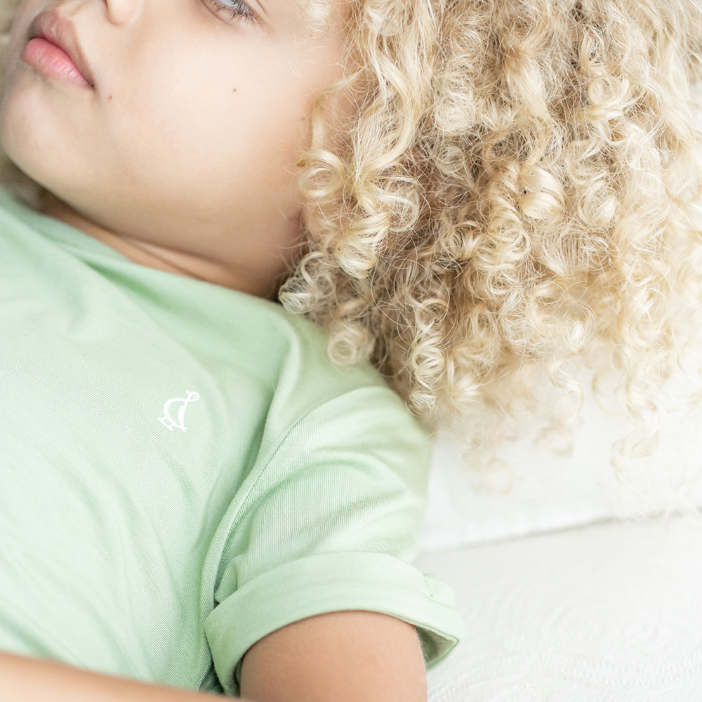 A child relaxing in RAPH&REMY® premium bamboo kids t-shirts