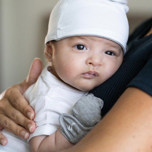 Baby wearing bamboo mittens by RAPH&REMY for scratch protection