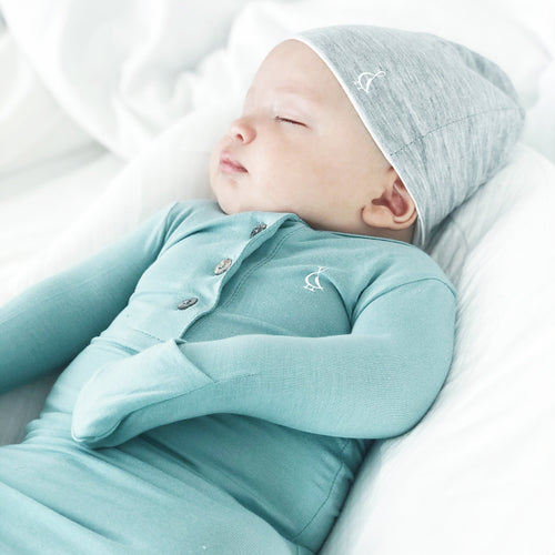 Baby sleeping soundly in knotted bamboo gown by RAPH&REMY®