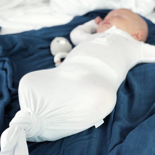 Peaceful baby nap time in bamboo sleep sack in white