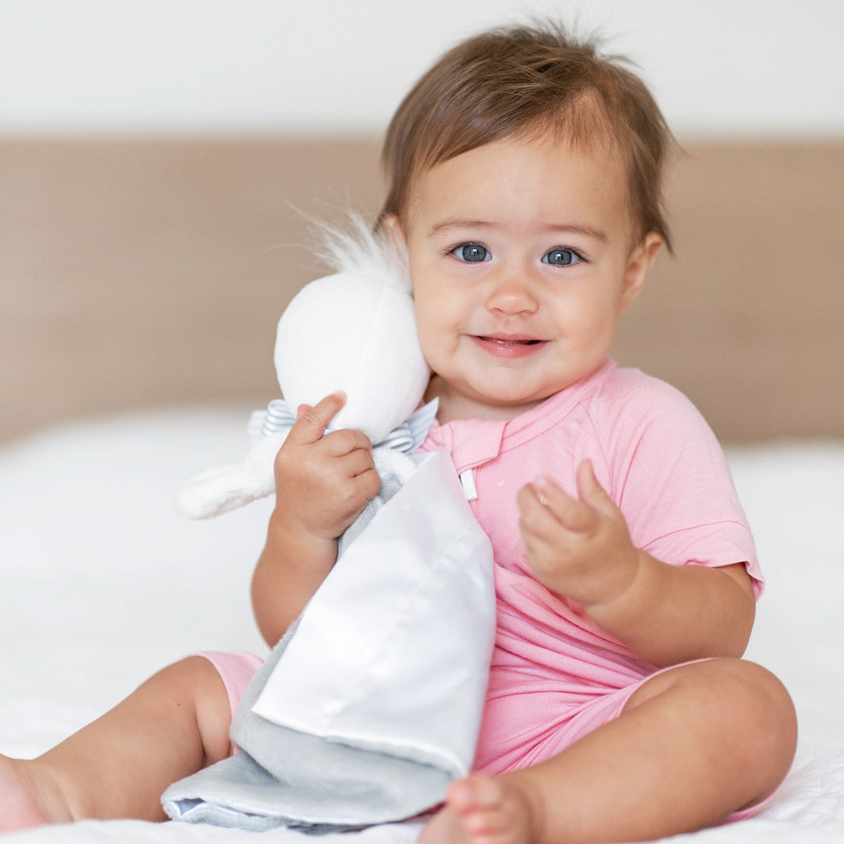 Happy baby holding soft bamboo SootherBuddy™ Security Blanket