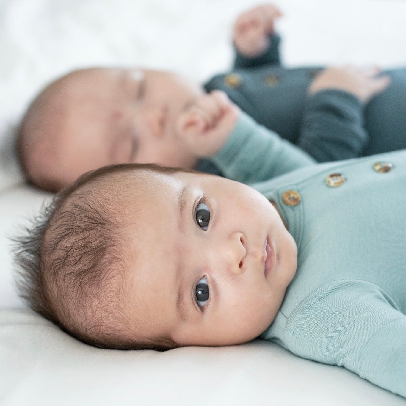 Newborn dressed in Premium Bamboo Sleep Gown on bed